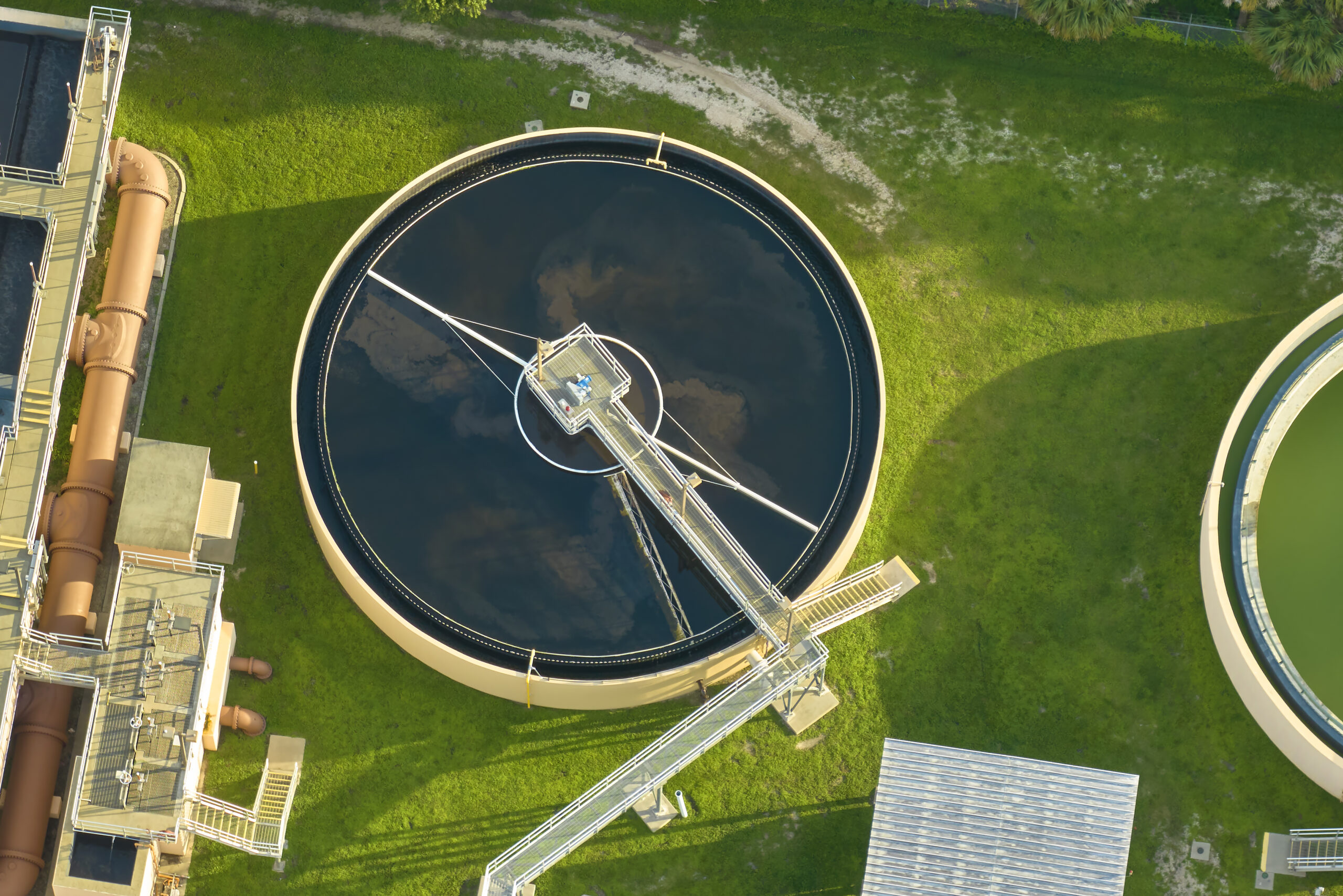 Aerial view of modern water cleaning facility at urban wastewater treatment plant. Purification process of removing undesirable chemicals, suspended solids and gases from contaminated liquid.