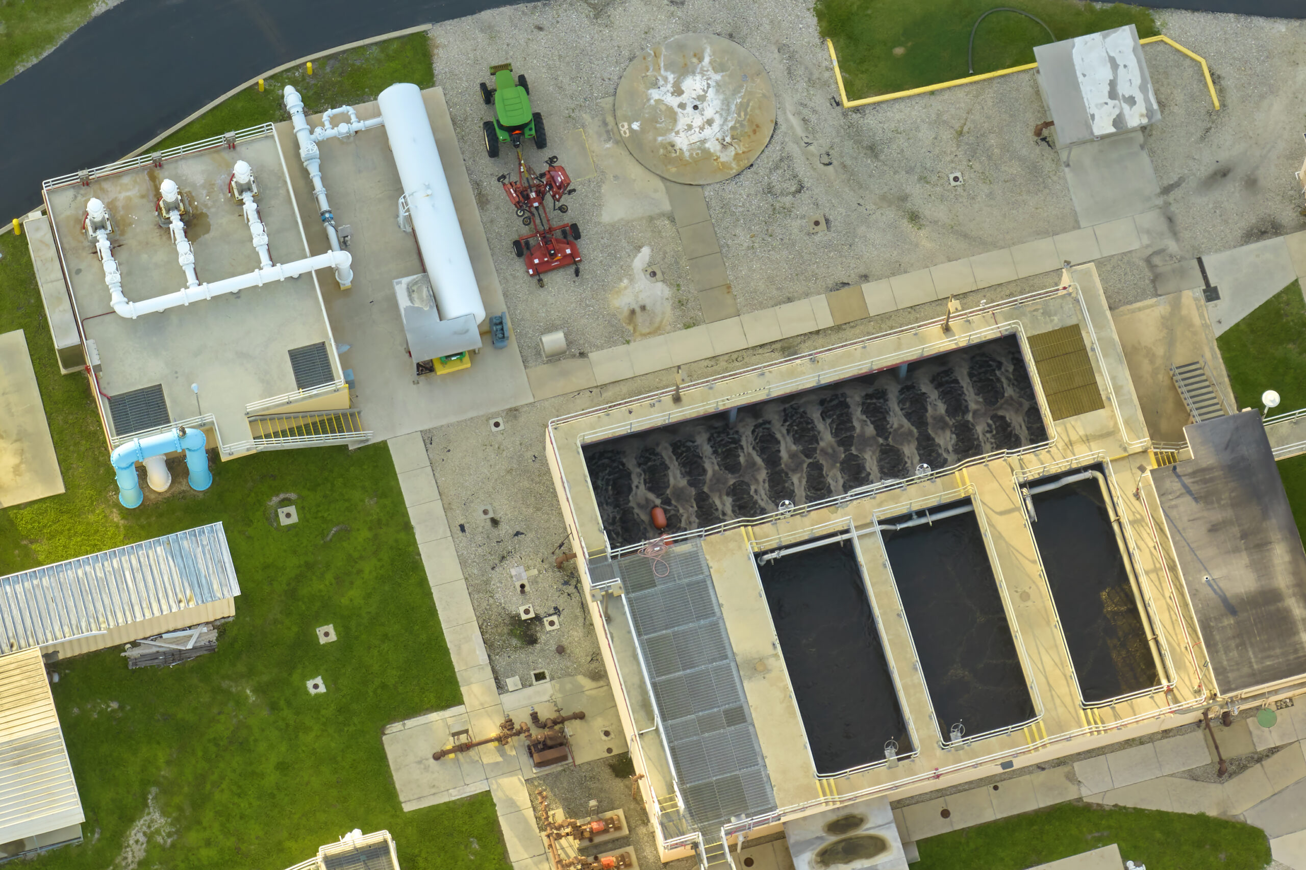 Aerial view of modern water cleaning facility at urban wastewater treatment plant. Purification process of removing undesirable chemicals, suspended solids and gases from contaminated liquid.